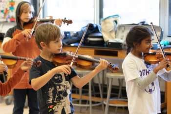 three young violin students