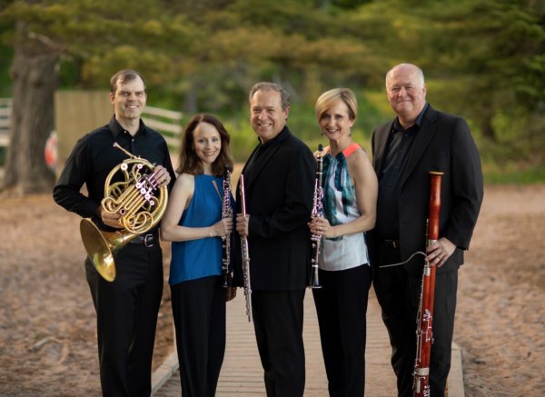 Five people standing holding instruments