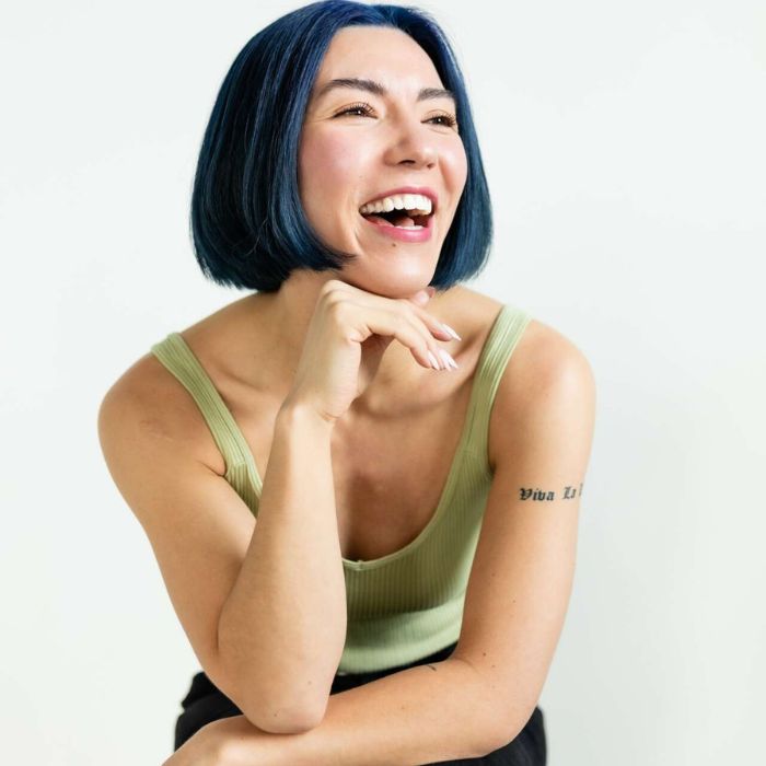 Person smiling with green tank top