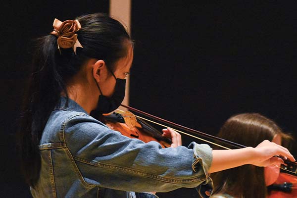 Young student playing violin