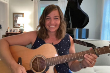 Cari playing a guitar