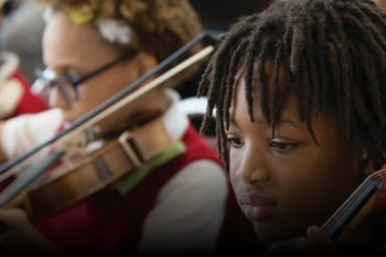 Group of students performing string instruments