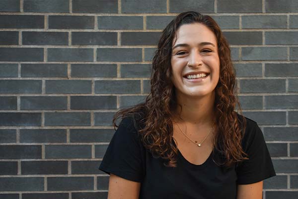 Headshot of Madelyn Herbrand. She has brown hair and is smiling.
