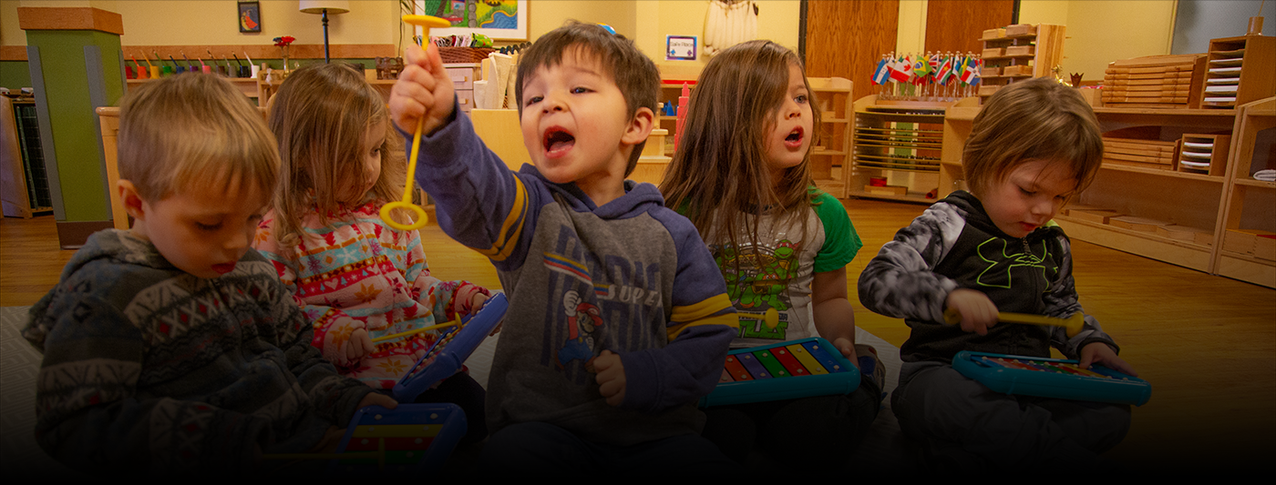 Early Childhood Music education - Sing Play Learn with MacPhail. Toddlers in classroom playing with instruments.