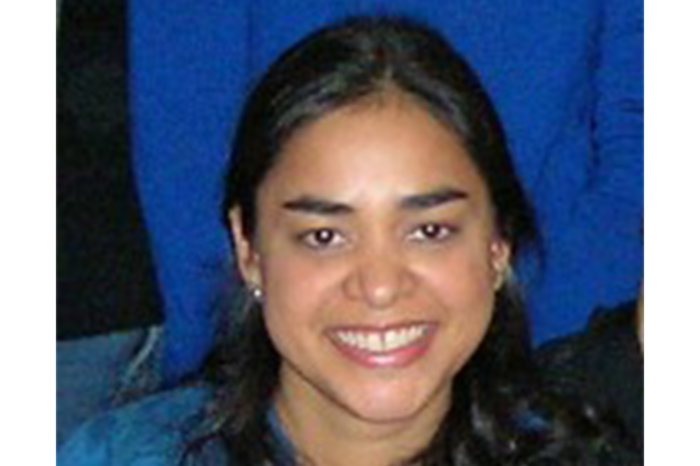 Headshot of Kamini LaRusso. She has long black hair and is smiling.