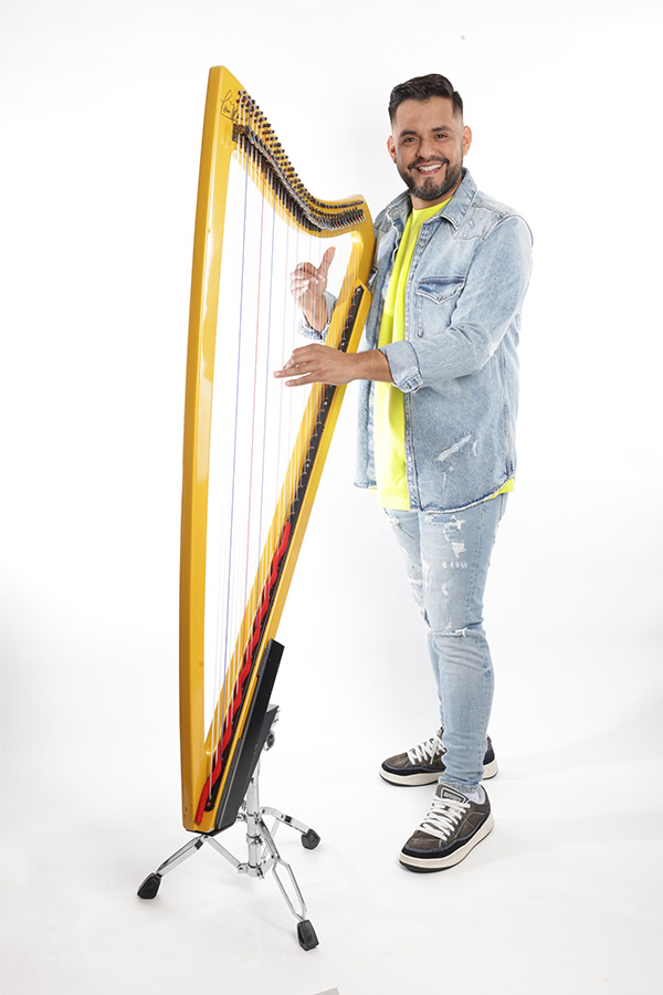 Leonard Jacome standing with a Harp.