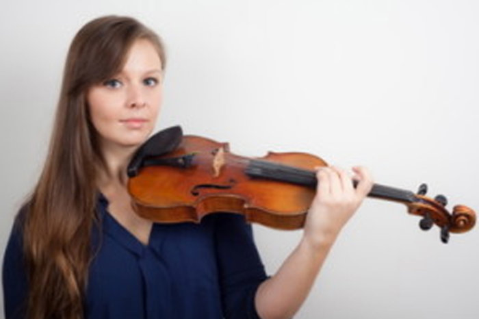 Claire holding a violin