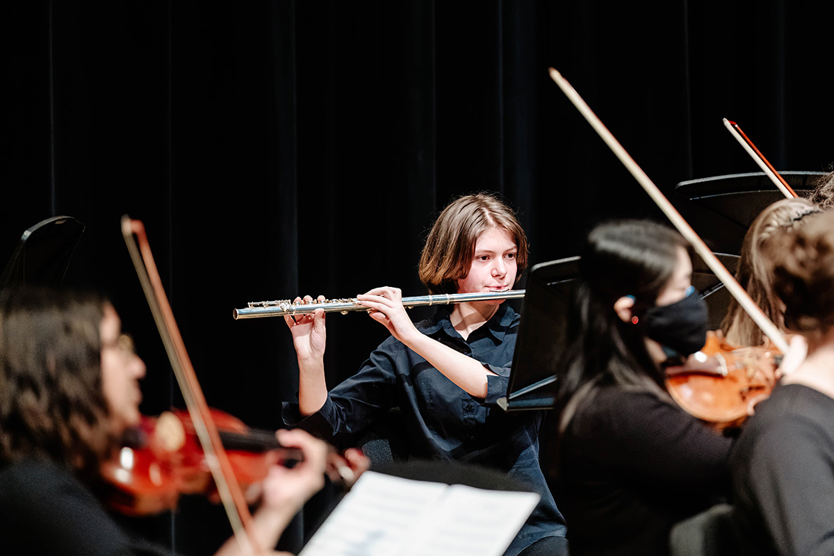 flute player in an orchestra setting