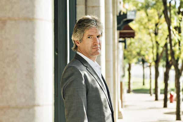 Person standing outside in a gray suit