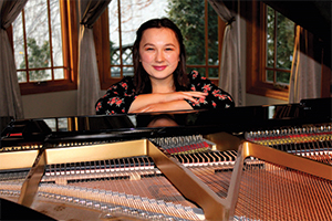 Student sitting at a piano