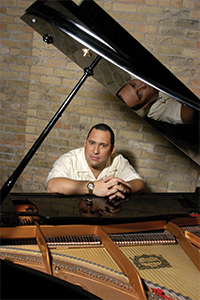 Nachito sitting at a piano