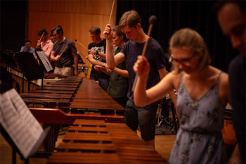 A group of performers holding mallets