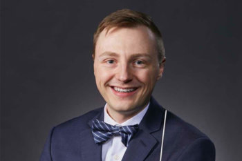 Headshot of Brent Platta. He has short hair and is smiling, wearing a suit and bowtie.