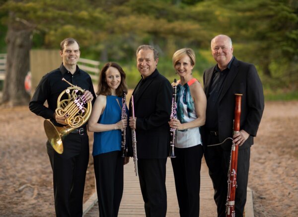 The prairie winds musicians posing outside with their instruments.