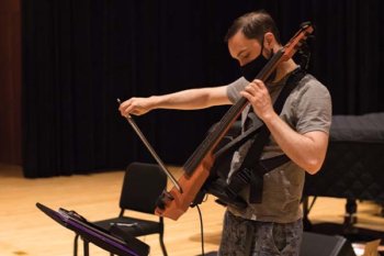 Person playing electronic cello