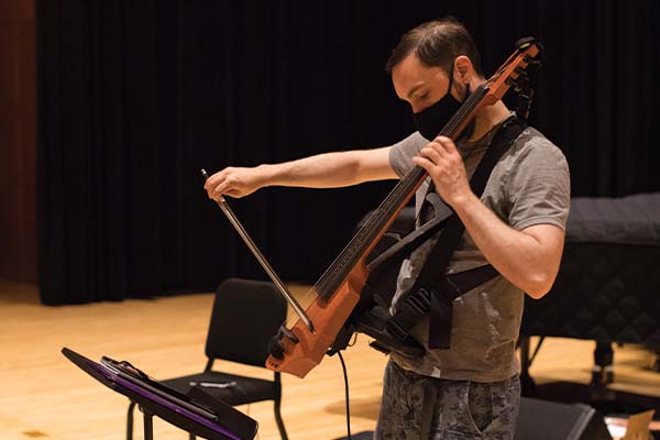 Person playing electronic cello