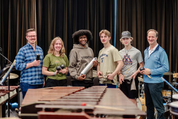 Paul Babcock and percussion students standing in front of marimbas