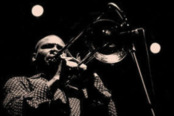 Black and white photo of Robin Eubanks playing trumpet