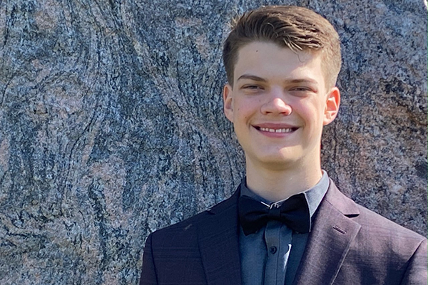 Person wearing a blue suit and a bowtie