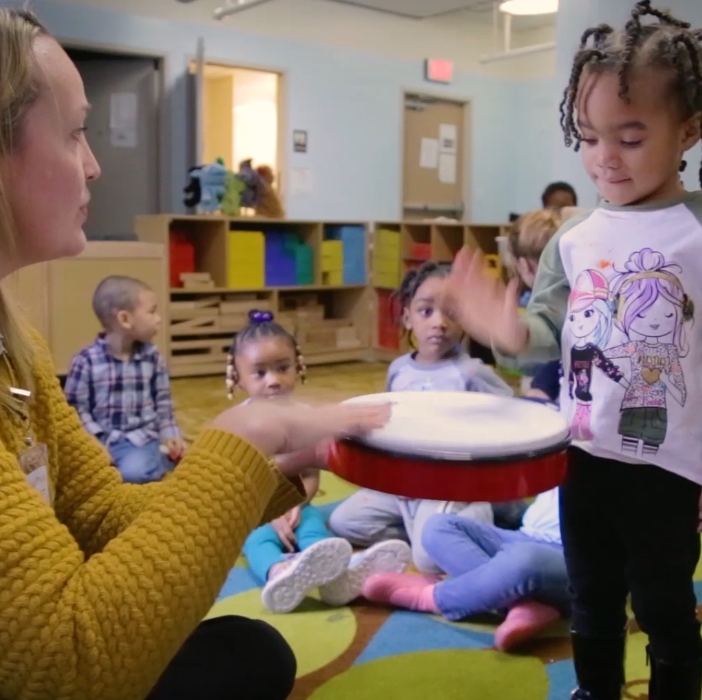 Teacher and student playing a drum