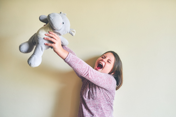 Child singing to a stuffed animal