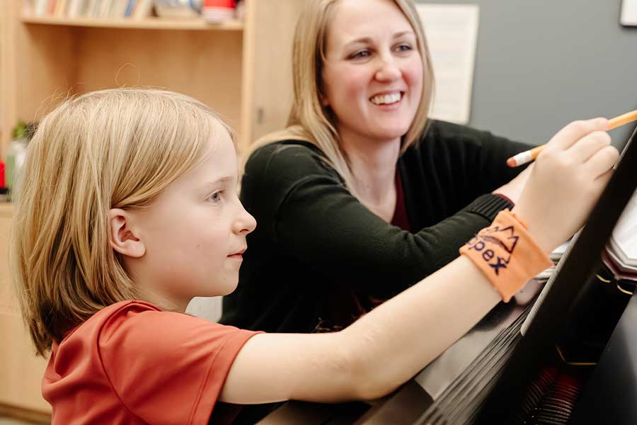 Student and teacher in a piano lesson