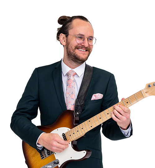 Tommy Boynton holding a guitar with design behind