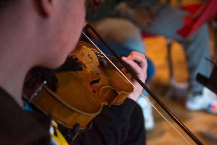 close up of a student playing violin