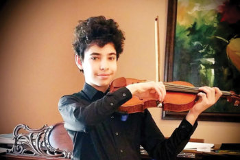 Young student wearing a black button up shirt and playing a violin