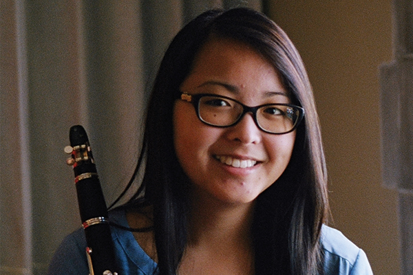 Headshot of Amy Wightkin. She is holding a clarinet.