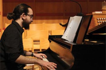 Side view of a person playing a piano