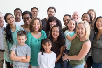 Large group of people, adults and children of all different races, standing together