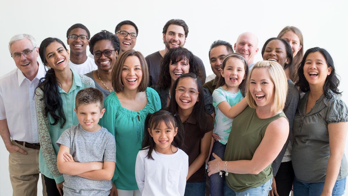 Large group of people, adults and children of all different races, standing together