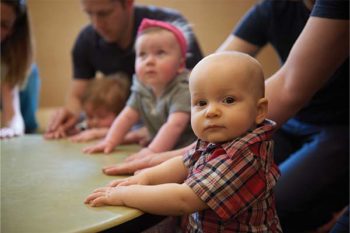 babies sitting around a drum