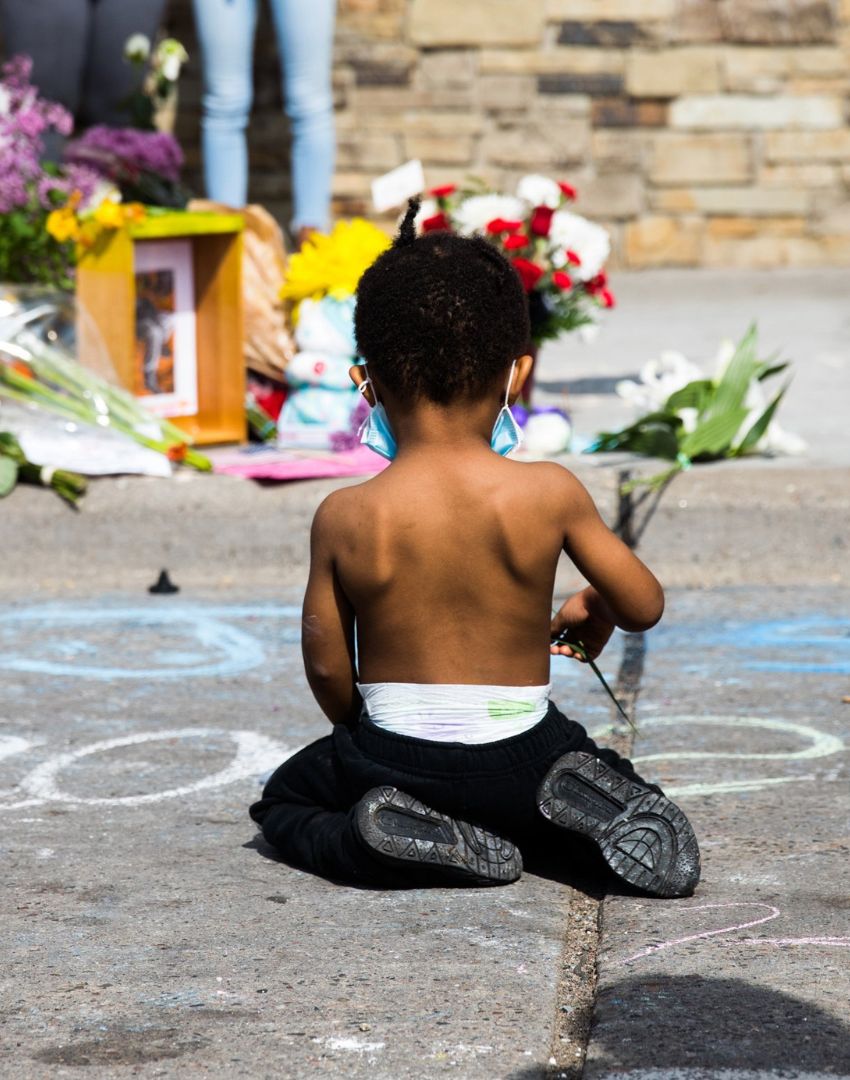 photograph of small boy kneeling at George Floyd memorial