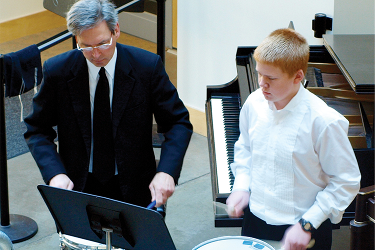Teacher and student playing snare drums
