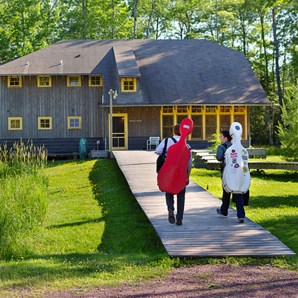 Two cellists walking at Madeline Island.