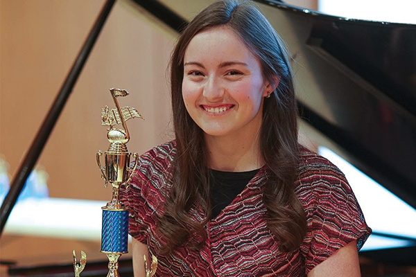 Student holding a trophy