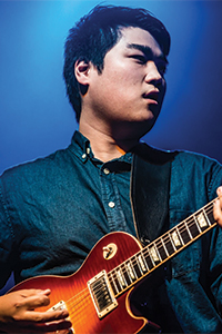 David playing an electric guitar