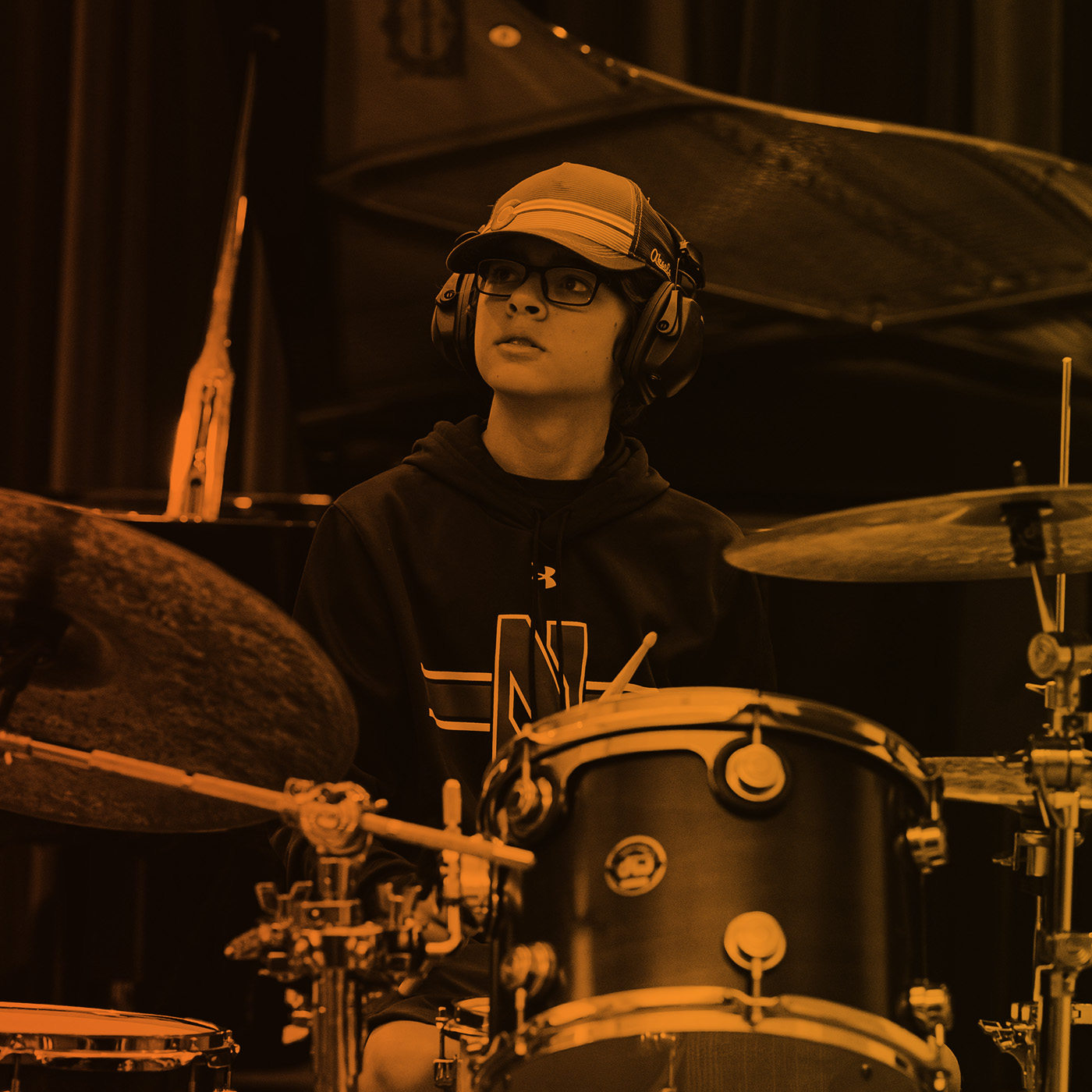 young student playing drum set