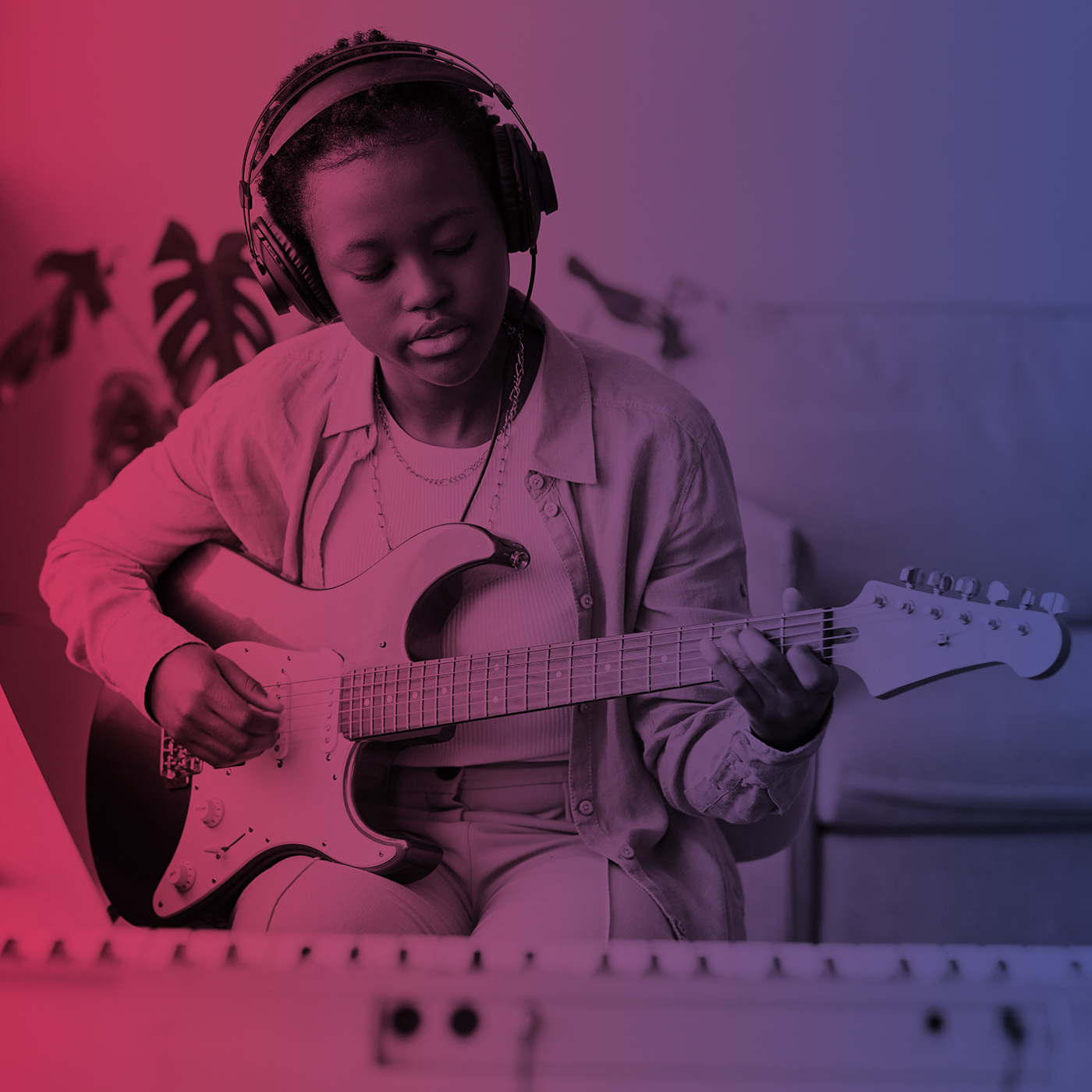 a girl playing electric guitar with recording equipment
