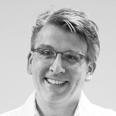 black and white photo of a person wearing a white button up shirt