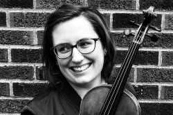 Black and white photo of a person holding a violin