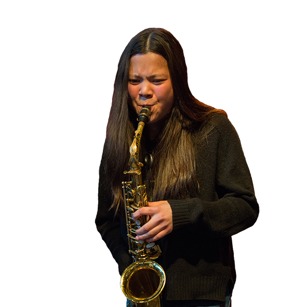 Student wearing a black sweater, playing saxophone