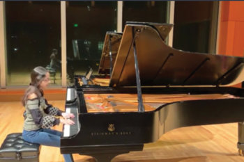 Student performing piano on stage