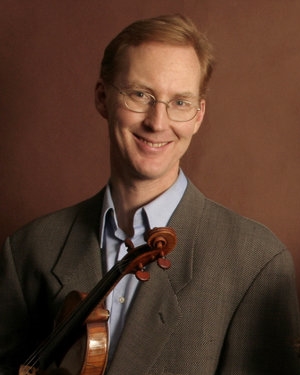 Peter holding a violin