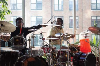 Two people playing drums