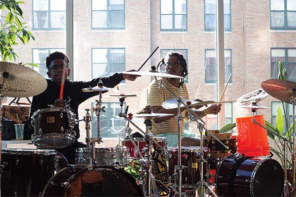 Two people playing drums