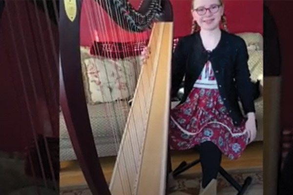 student playing the harp