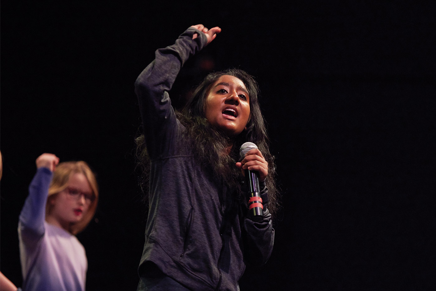 Student singing into a microphone